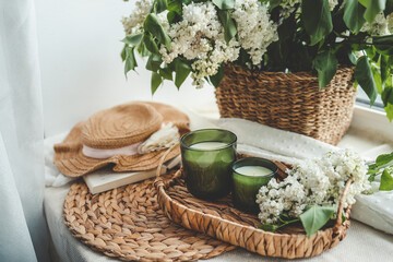 Two candles and a basket of white lilacs, aesthetic photo