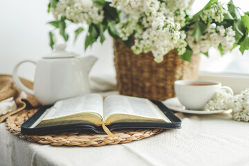 Open bible in spring interior, good morning concept