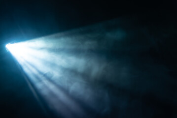 blue spotlight light beam on black background - obrazy, fototapety, plakaty