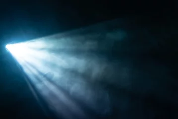 Foto op Plexiglas blue spotlight light beam on black background © nazarioking