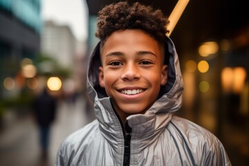 Close-up portrait photography of a happy mature boy wearing a lightweight windbreaker against a lively downtown street background. With generative AI technology
