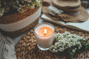 Burning candle in spring interior
