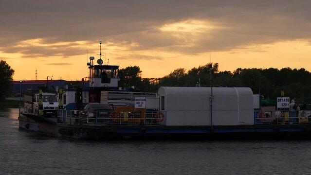 4K video with a ferry transporting people and cars from Braila to Macin cities in Romania. Transportation over Danube river. Romania, 2023.