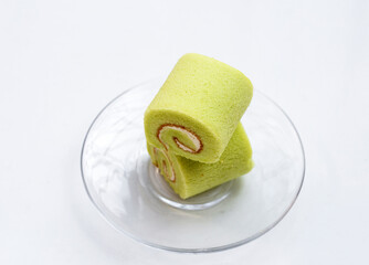 Pandan roll cake on white background.