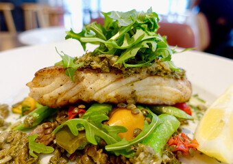 Close up of grilled seafood with vegetables in a restaurant pov