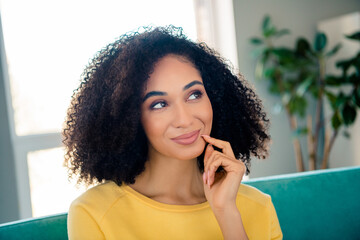 Photo of minded optimistic woman with perming coiffure wear yellow long sleeve finger on cheek...