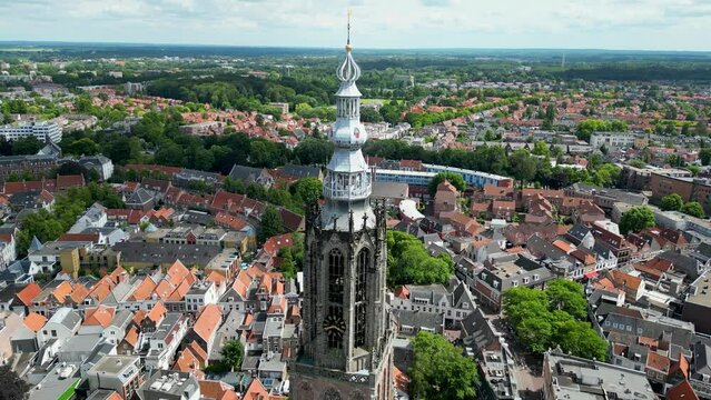 This aerial drone video shows the Lieve Vrouwentoren, a large clock tower in the old city center of Amersfoort. Amersfoort is a beautiful city in Utrecht, the Netherlands.