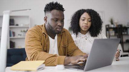 African American couple applying for mortgage loan online to buy a new home