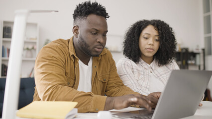 Young black couple reviews options and provides feedback as they choose an apartment to rent