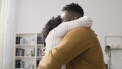 Caring husband hugs his wife to congratulate her on her job promotion, happy couple