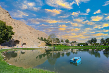 Mountains and clean water lake in beautiful persian valley with historical rocky reliefs on October...