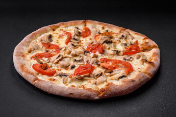 Delicious pizza with chicken, tomatoes and cheese with salt and sauce