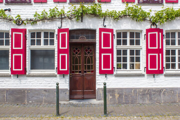 Old German house with wooden door and windows with wooden shutters, Wachtendonk