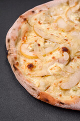Delicious sweet pizza with pear, dorblu cheese and nuts