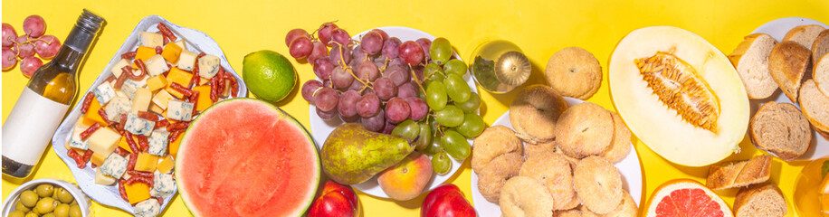 Buon Ferragosto (happy in italian language) holiday background. Summer Italian harvest festival August 15  brunch, family party antipasto foods with watermelon, melon, grapes, cheese, snacks, drinks