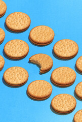 Pop art with cookies over violet background flat lay top-down composition. Confectionery product food pattern