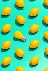 Fruit pattern of fresh, juicy lemons on acid green background. Top view. Food pop art design, creative summer concept