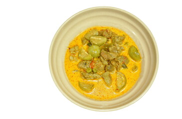 spicy boiled beef meat with eggplant in coconut milk green curry soup on bowl  
