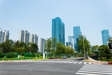 Empty road with zebra crossing and skyscrapers