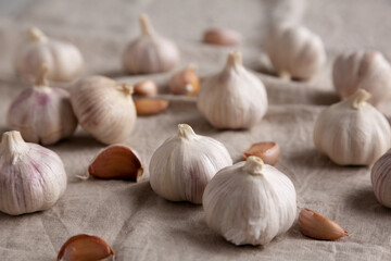 Raw Organic White Garlic Bulbs on a cloth, side view. Close-up.