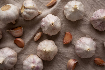 Raw Organic White Garlic Bulbs on a cloth, top view. Flt lay, overhead, from above.