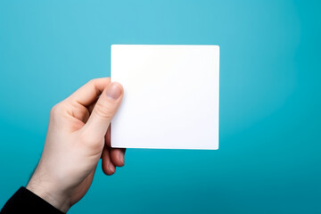 Obraz premium empty white blank mockup in hand on blue background generative ai