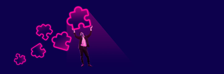 Businessman, employee holding neon colored puzzle icons symbolizing well-coordinated teamwork and professional assistance. Creative conceptual design. Concept of business, office, modern technologies