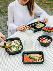Picnic, wooden table, outdoors, food in boxes
