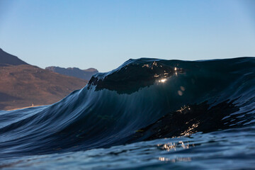 crystal clear wave breaking in dark water