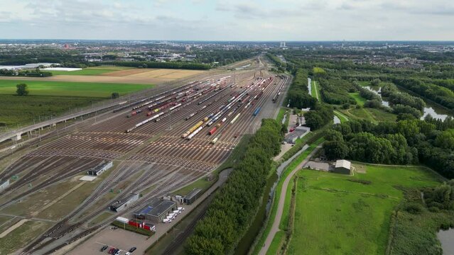 This aerial drone video shows the large marshalling yard named the Kijfhoek in Barendrecht, the Netherlands. There are many freight trains and containers on this railway tracks from the port. 