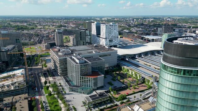 This aerial drone video shows several office buildings in the city center of Utrecht. The offices are located next to the Utrecht central station in the Netherlands. 