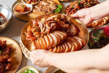 Jokbal, pork feet, steamed, salted oysters, spicy, noodles, garlic Korean food dish 