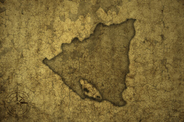 map of nicaragua on a old vintage crack paper background .