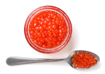 Red caviar in a glass jar and a spoon on a white background. Top view