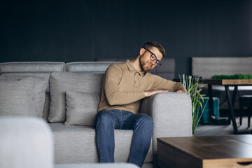 Fototapeta premium Man in furniture store choosing sofa