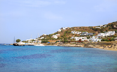 Fototapeta na wymiar Mykonos is a small Island of the Coast of Greece. The hilly coastline is adourned with white washed cottages. It is a very popular tourist destination.