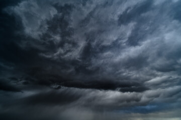 storm sky, dark dramatic clouds during thunderstorm, rain and wind, extreme weather, abstract background