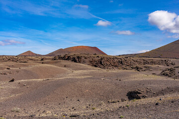 Lava of an extinct volcano in a valley on the Canary Island. Volcanic coast. Tourism.