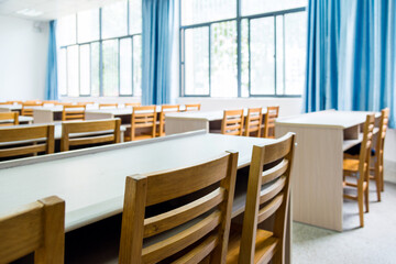 Fototapeta na wymiar Empty classroom with chairs, desks and chalkboard
