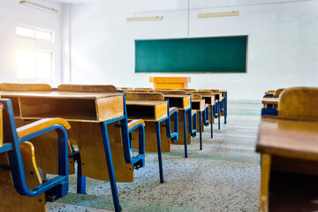 Empty classroom with chairs, desks and chalkboard