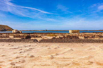 Stone barriers on the seashore. Small stone construction. Mountains of the Canary Islands.