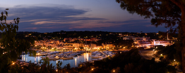 Naklejka premium A night view panorama of Porto Cervo village, an Italian luxury summer resort in Sardinia. A mesmerizing display of elegance and luxury.
