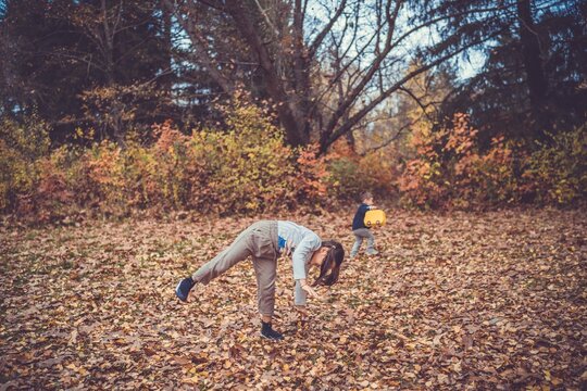 Child in the forest smiling and playing