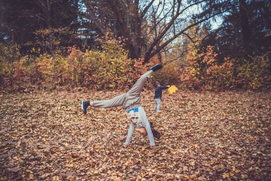 Child in the forest smiling and playing