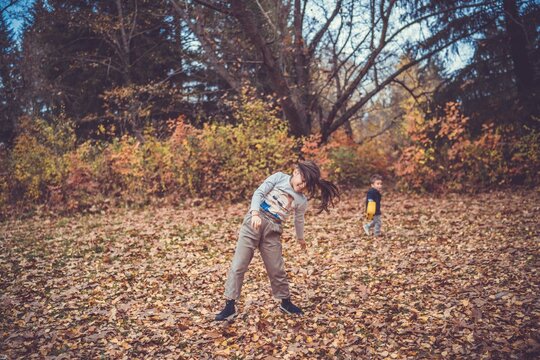 Child in the forest smiling and playing
