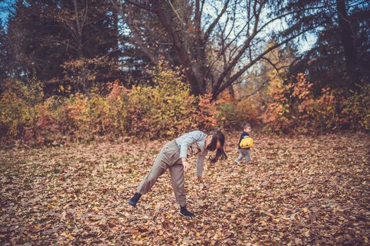 Child in the forest smiling and playing