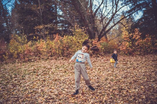Child in the forest smiling and playing