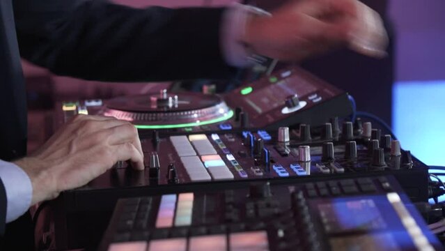 A DJ Works On His Sound Mixing Board At An Event - Closeup