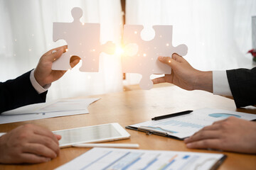 business owner are use jigsaw puzzle identify business cooperation. financial data analysis and...