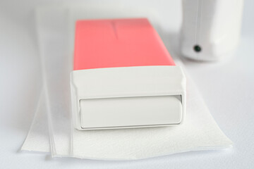 Hot film wax for depilation procedure and depilatory stripes on white background